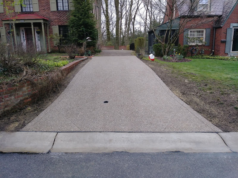 Driveway with brick retaining wall built by Mastercraft Masonry