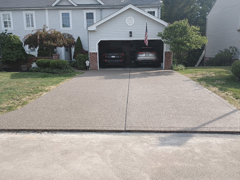 Exposed-aggregate concrete driveway poured by Mastercraft Masonry