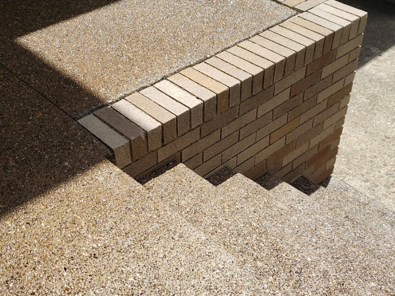 Stepped brick retaining wall and steps built by Mastercraft Masonry, photographed by a customer
