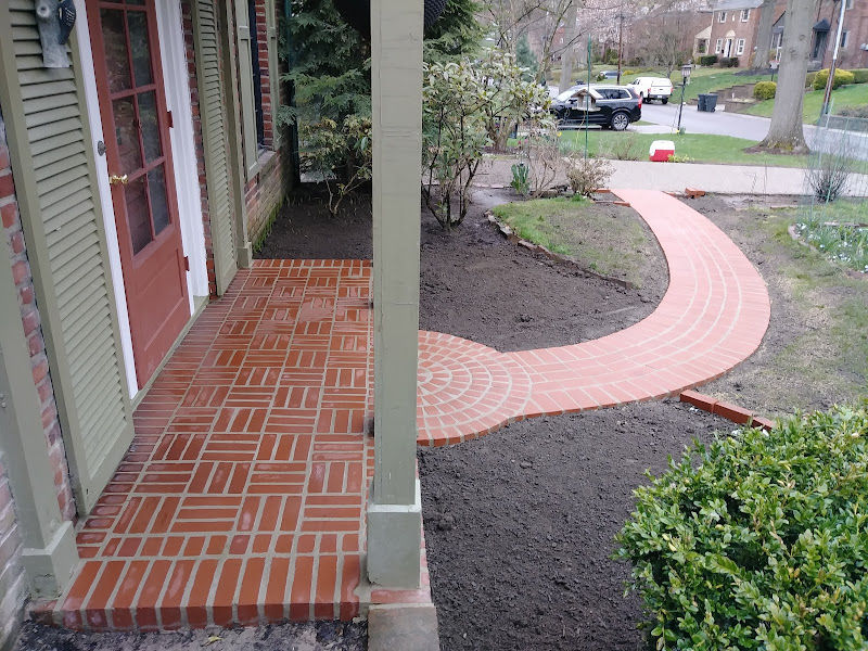 Curved herringbone brick walkway and porch built by Mastercraft Masonry